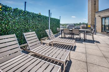 Rooftop with lounge seating and grills at nw apartments